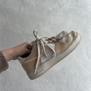 custom Nike Air Force 1 sneakers in a beige, ivory, and brown colorway